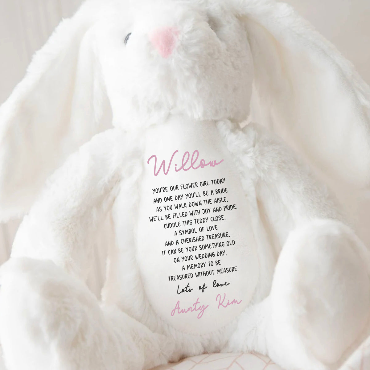 A white soft bunny toy with a beautiful flower girl quote on the front