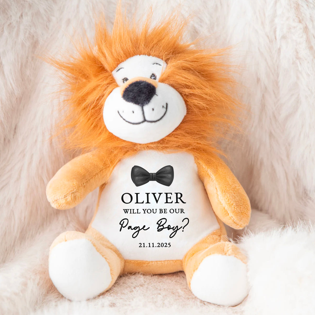 A Lion teddy soft toy used as a page boy proposal gift. The proposal asks "will you be our page boy?" Wedding date added below