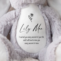 Close up of a soft grey bunny toy with a quote about baby loss / child loss.