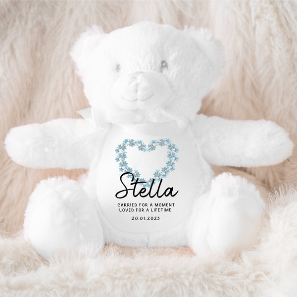 A soft white teddy representing baby loss Our Memorial Teddy offers a way to honour the memory of a precious soul and provide comfort.